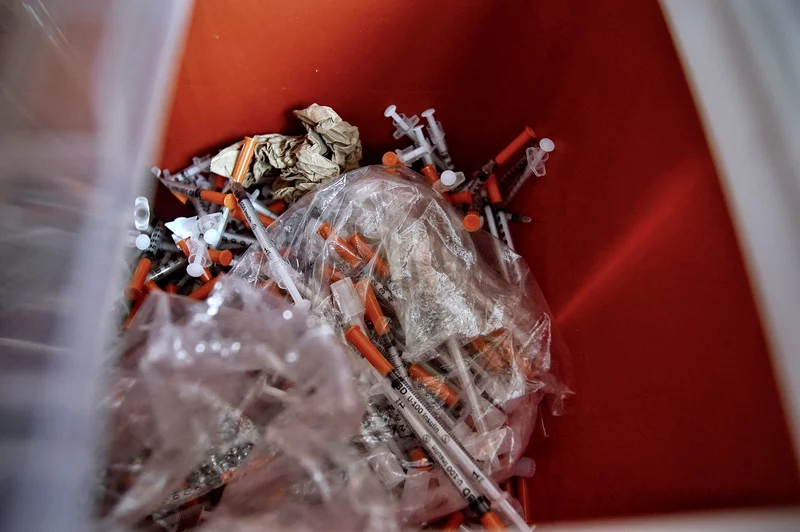 Used syringes in a container